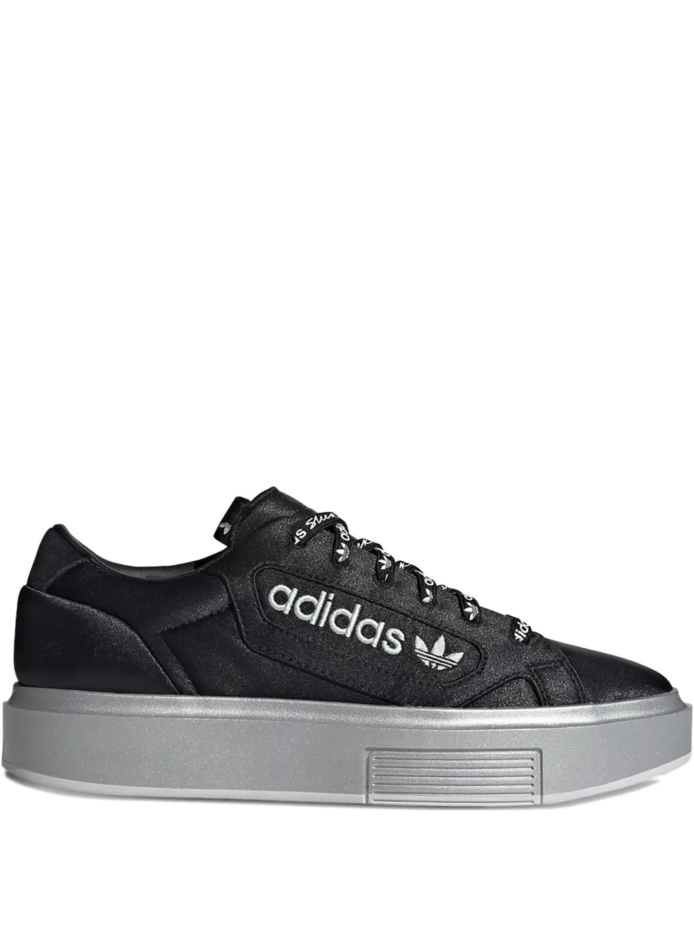 Black adidas low-top sneakers with trefoil logo and gray platform sole