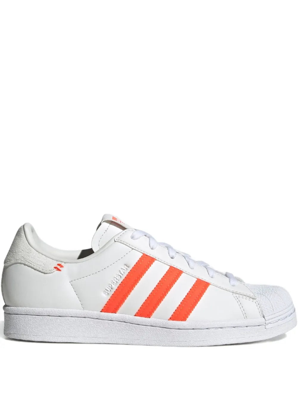 adidas Superstar low-top sneaker in white with orange three-stripe side