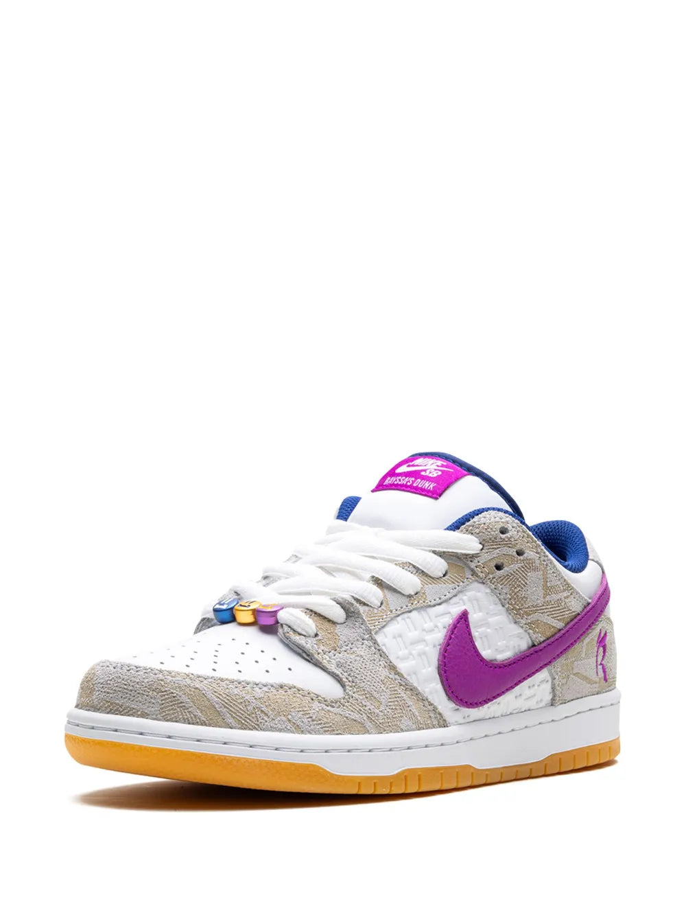 Low-top sneakers with white laces, purple heel and Swoosh, tan patterned overlays