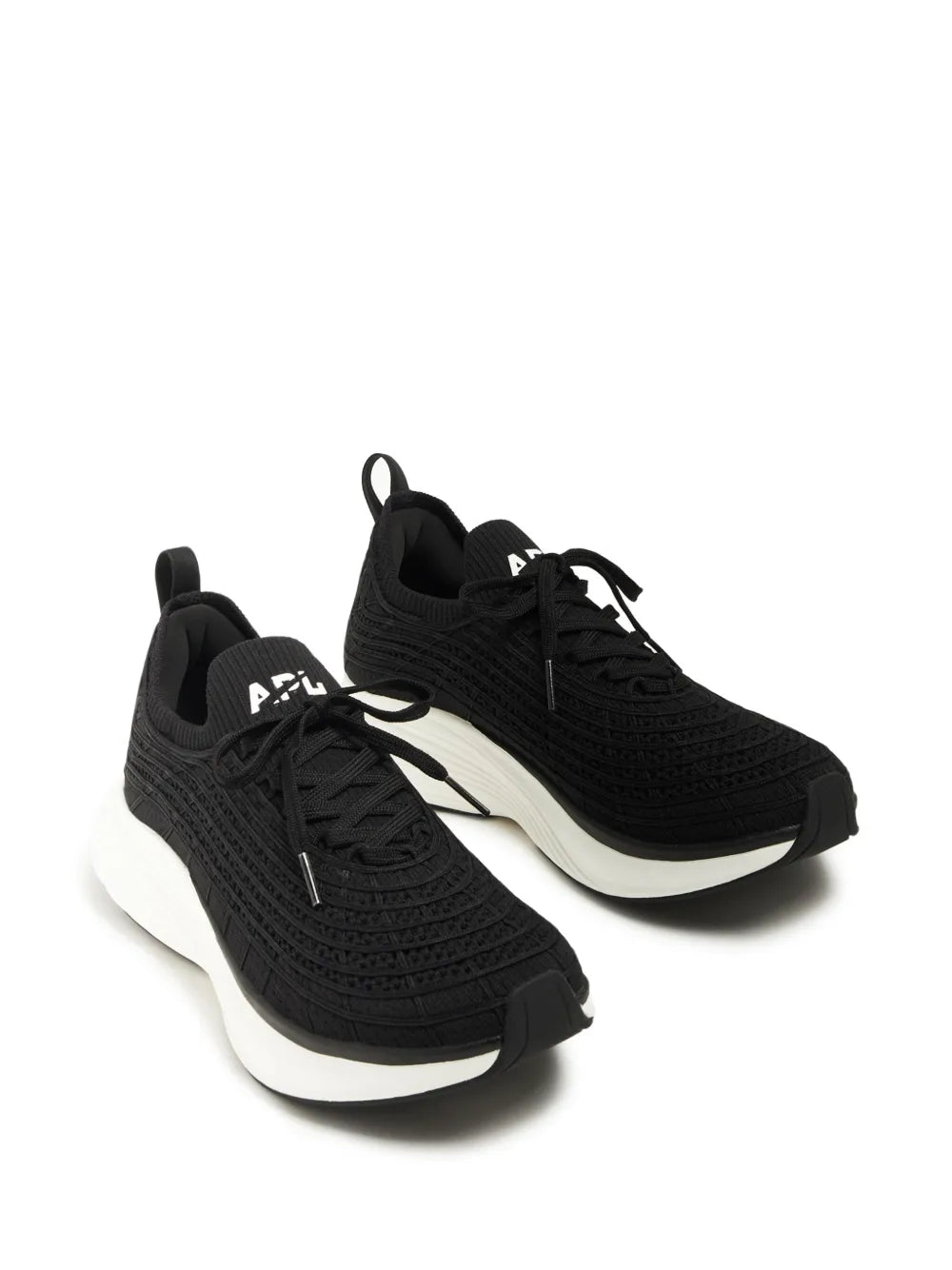 Black APL lace-up running shoes with knit texture and white soles, pair view