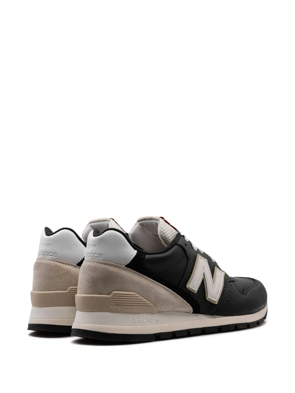 New Balance 996 low-top sneaker heel view in black and beige with padded collar