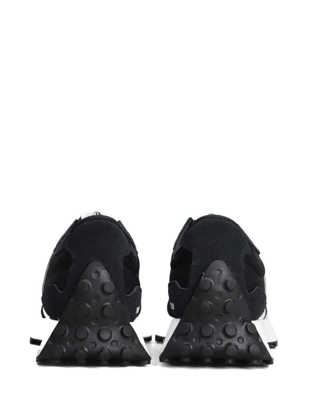 Black sneakers with textured rubber pods at the heel and grippy tread
