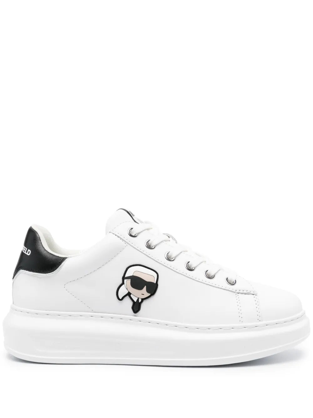 White leather low-top trainers with black heel panel and cartoon logo patch