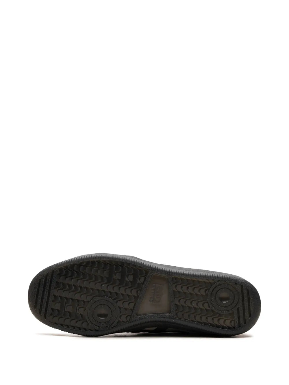 Black rubber outsole with tread pattern and circular grip icons