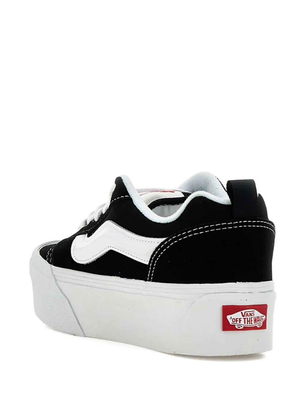 Black low-top sneakers with white side stripe and Vans heel patch