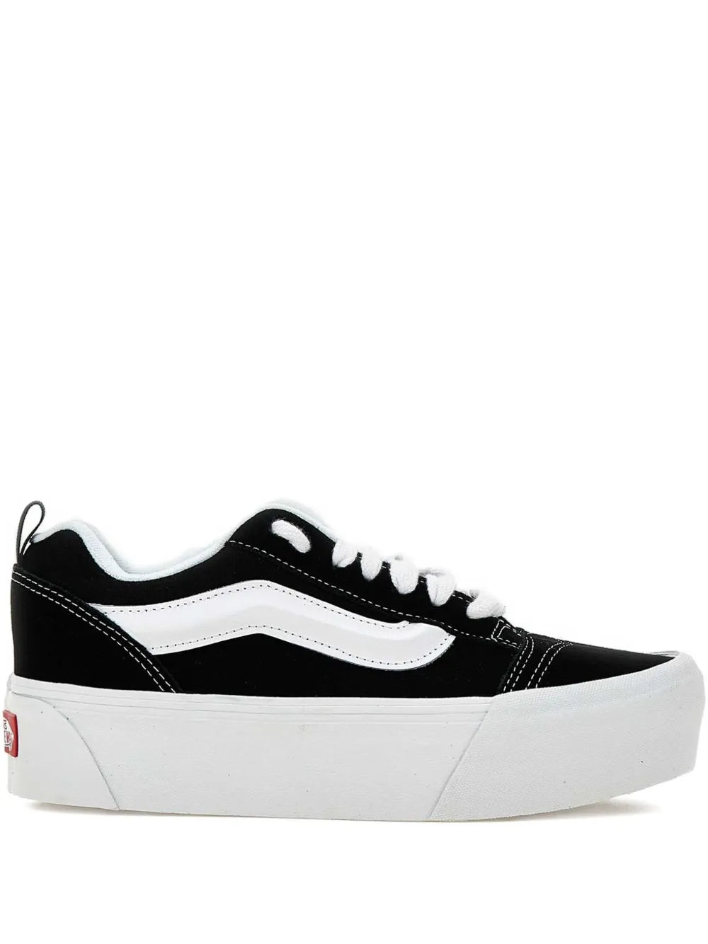 Black and white low-top sneakers with white midsole and side stripe