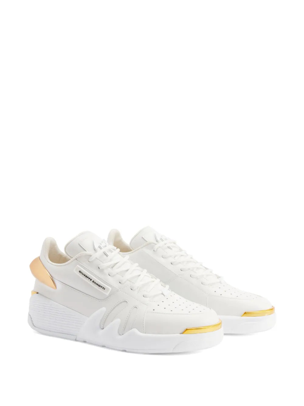 White low-top sneakers with gold-trimmed sole edge, lace-up front, side logo