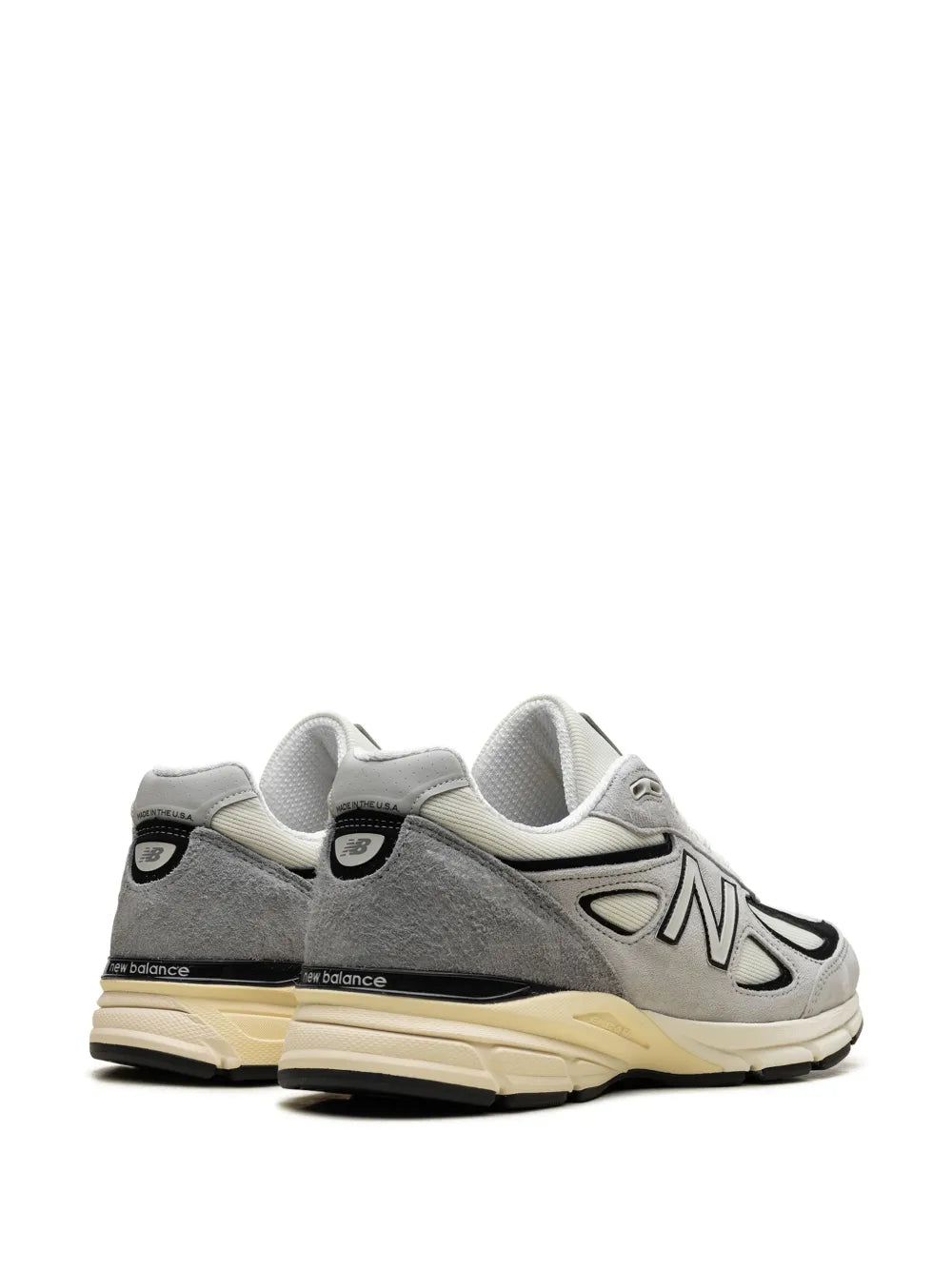 New Balance 990V4 sneaker pair view, gray upper with black accents and cream sole