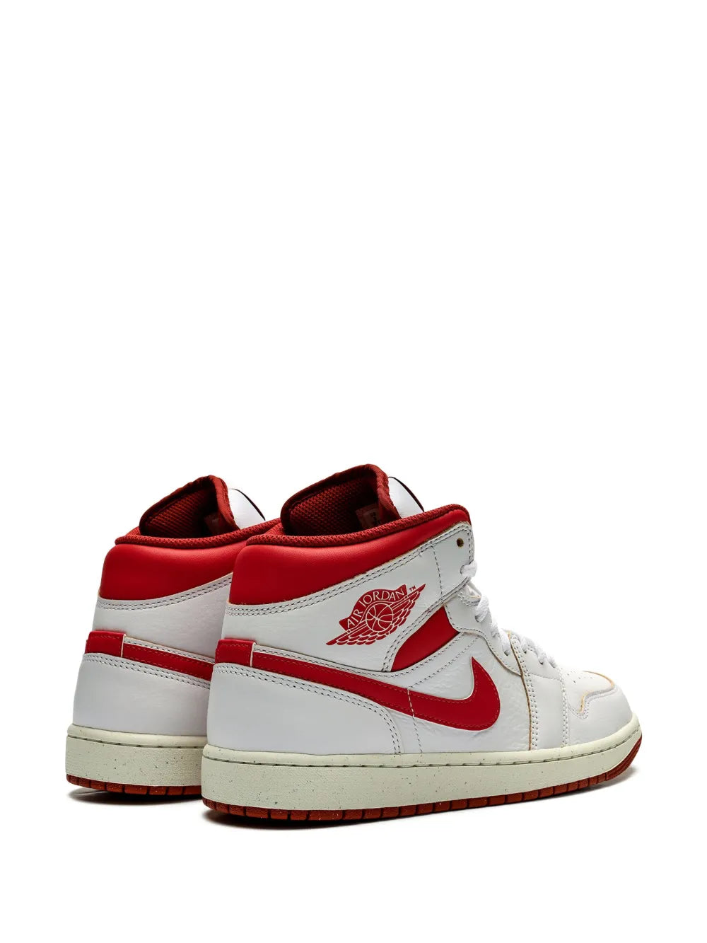 Air Jordan 1 Mid SE white high-top sneakers with red heel panels and tongue badge