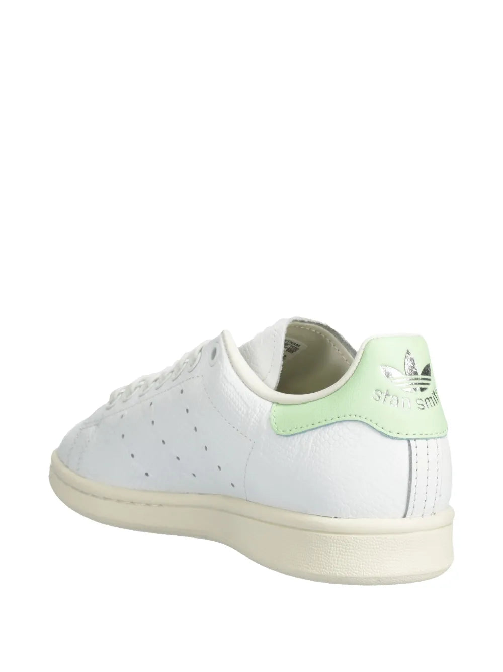 White low-top sneaker with green collar lining and heel logo; lace-up design.