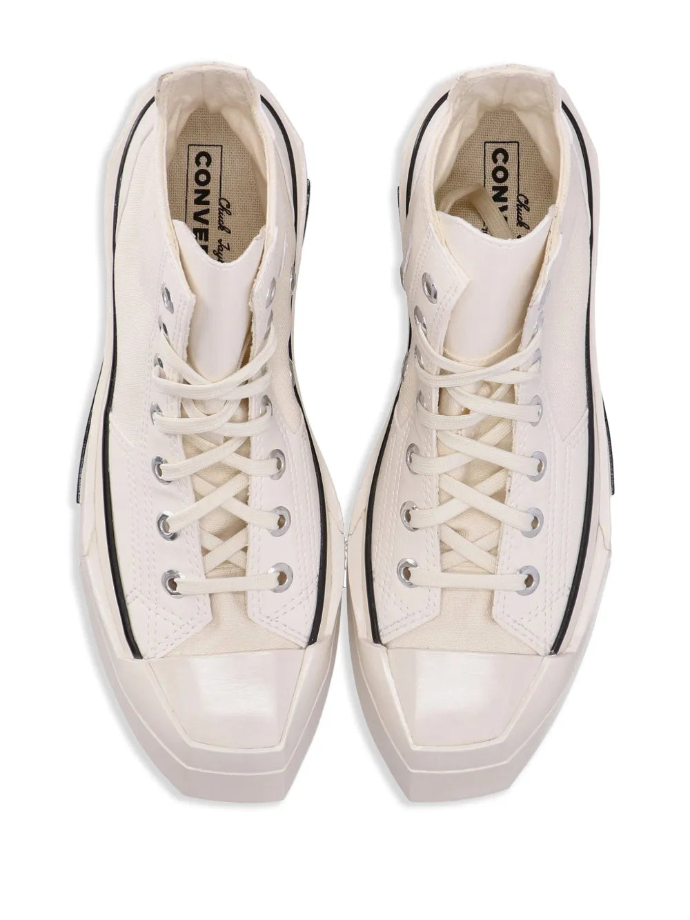 Pair of off-white high-top sneakers with laces and Converse logo lining