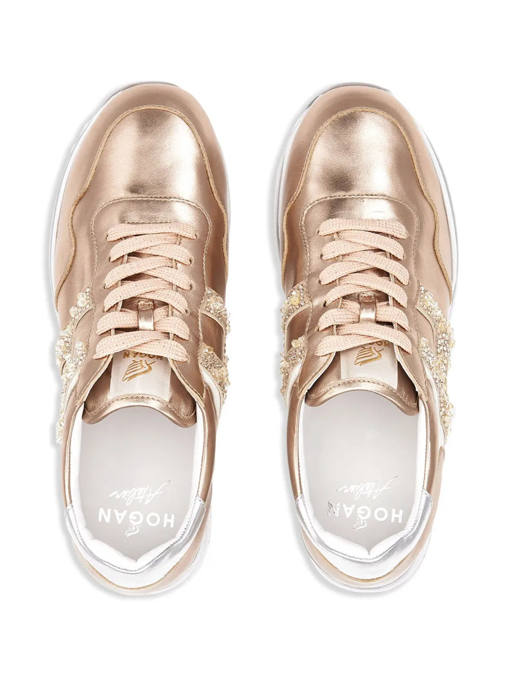 Pair of gold-tone metallic sneakers with laces and rhinestone trim on the side