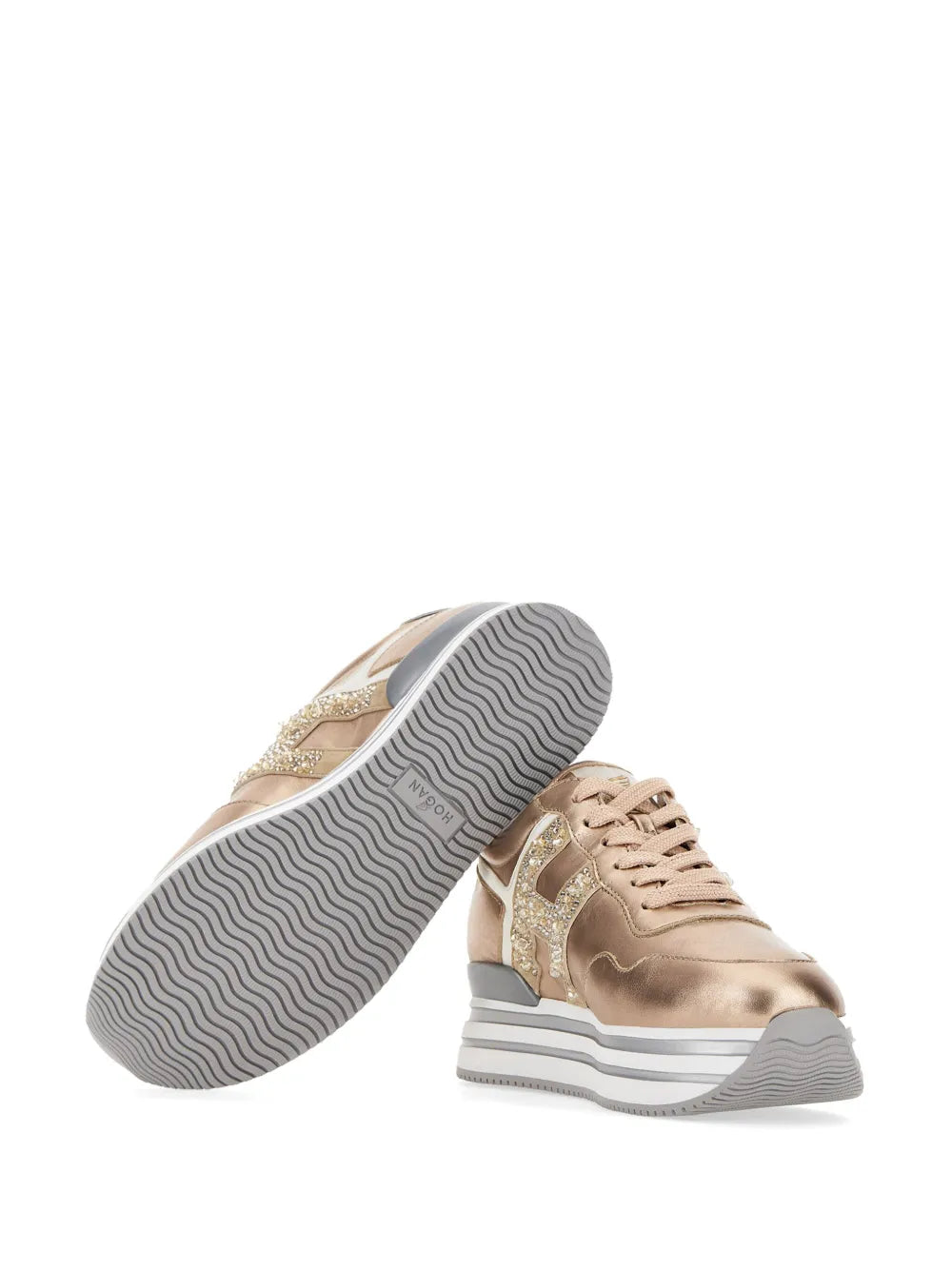 Bottom view of gold-tone metallic platform sneakers with textured rubber outsole