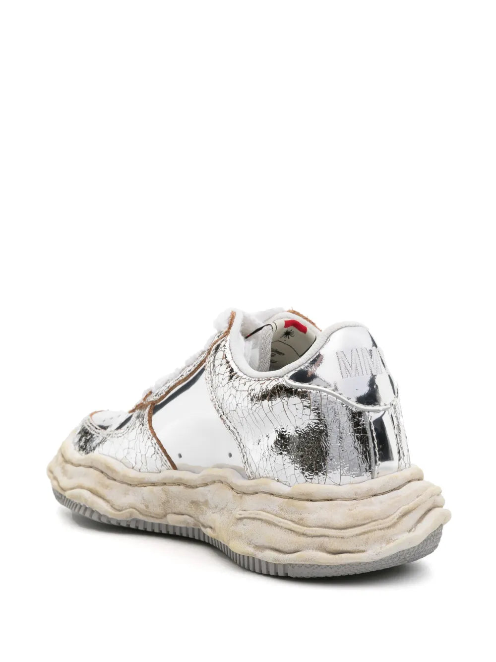 Low-top sneaker with white upper, shiny silver heel and side, beige textured outsole