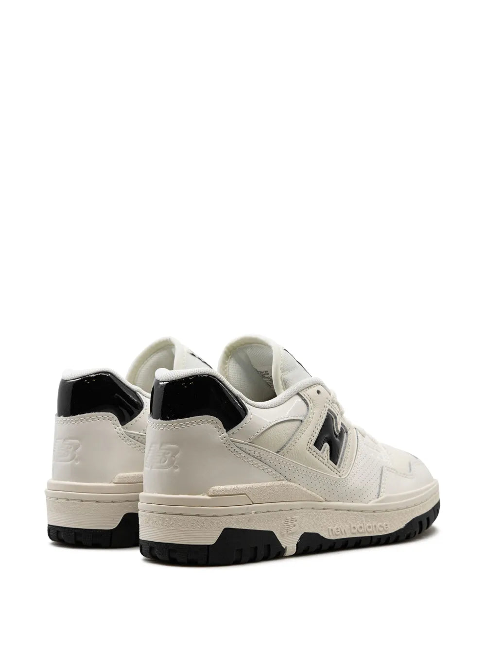 Pair of New Balance 550 sneakers from heel view, white uppers with black rear panels