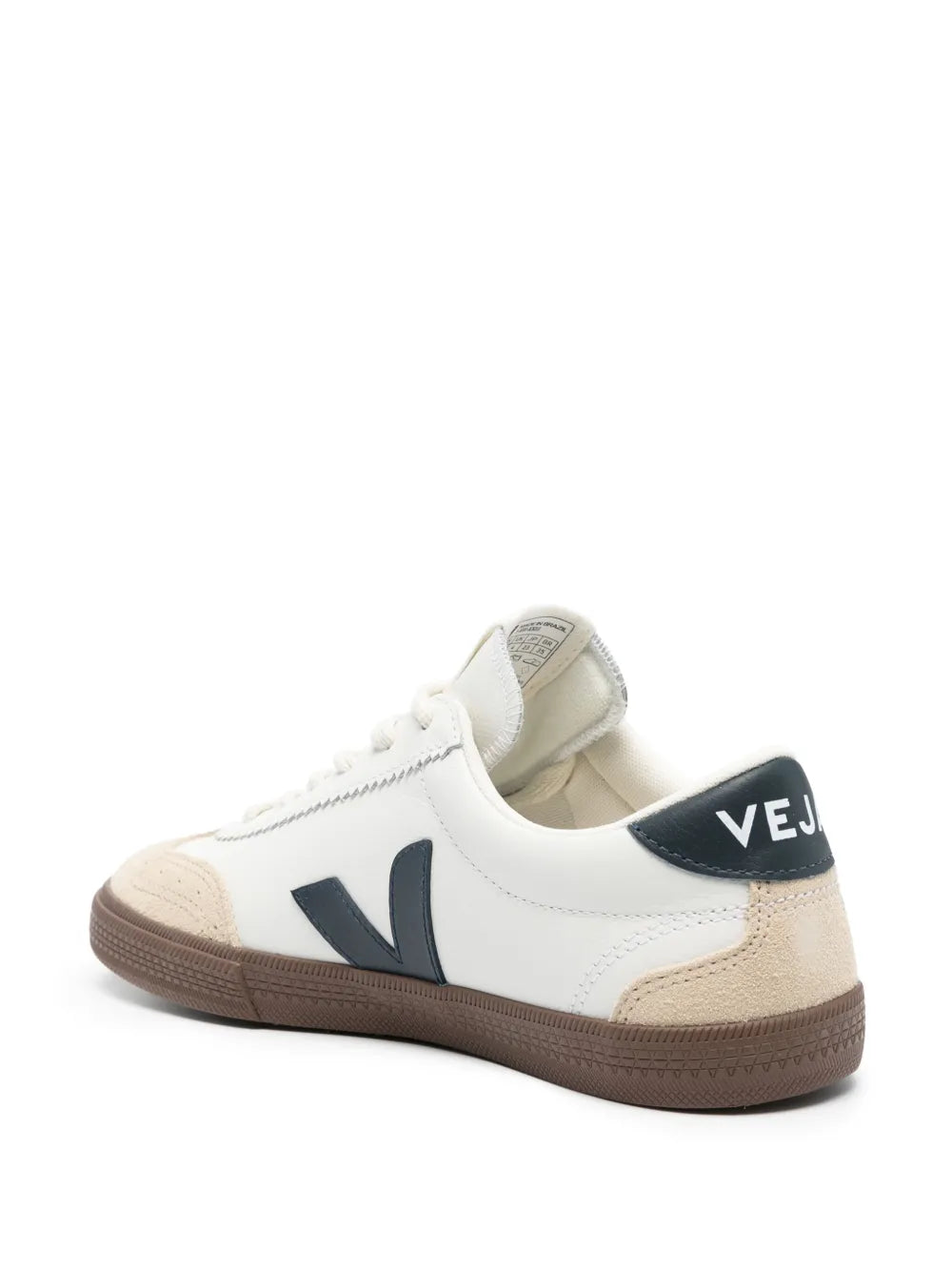 White and beige low-top sneakers with navy heel panel and V logo