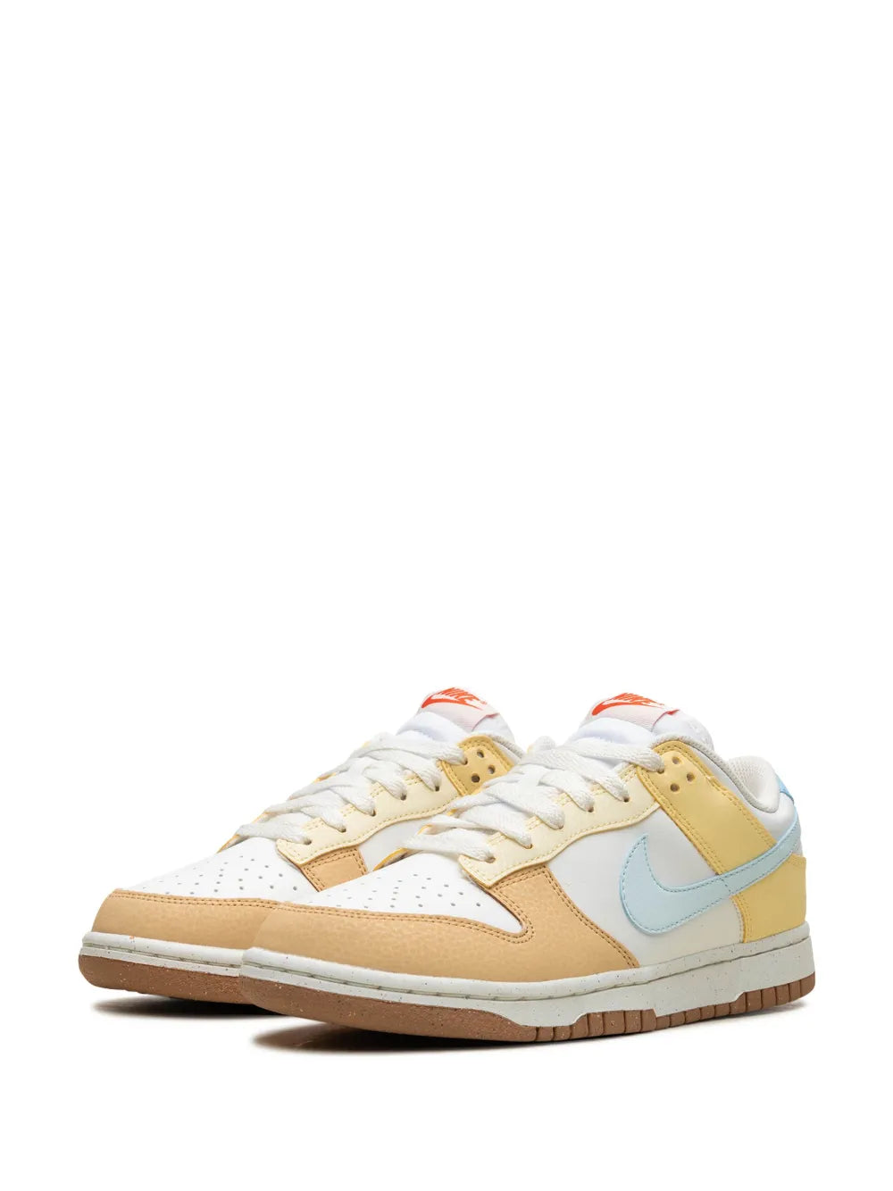 Nike Dunk Low low-top sneakers, two shoes in white with tan and light-blue accents