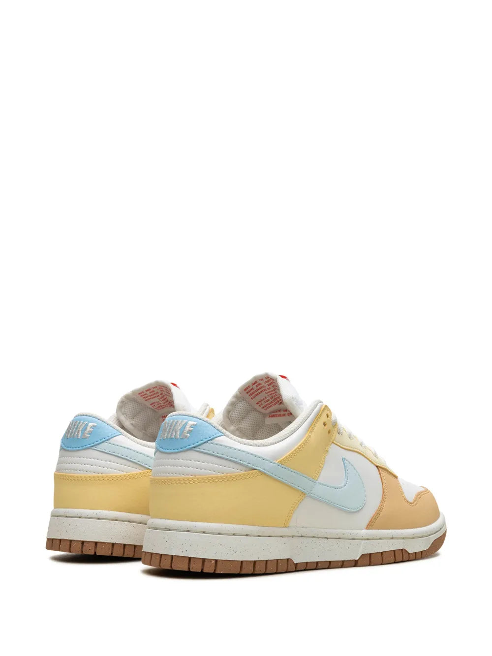 Nike Dunk Low sneaker heel view in white with light-blue and tan panels, gum sole