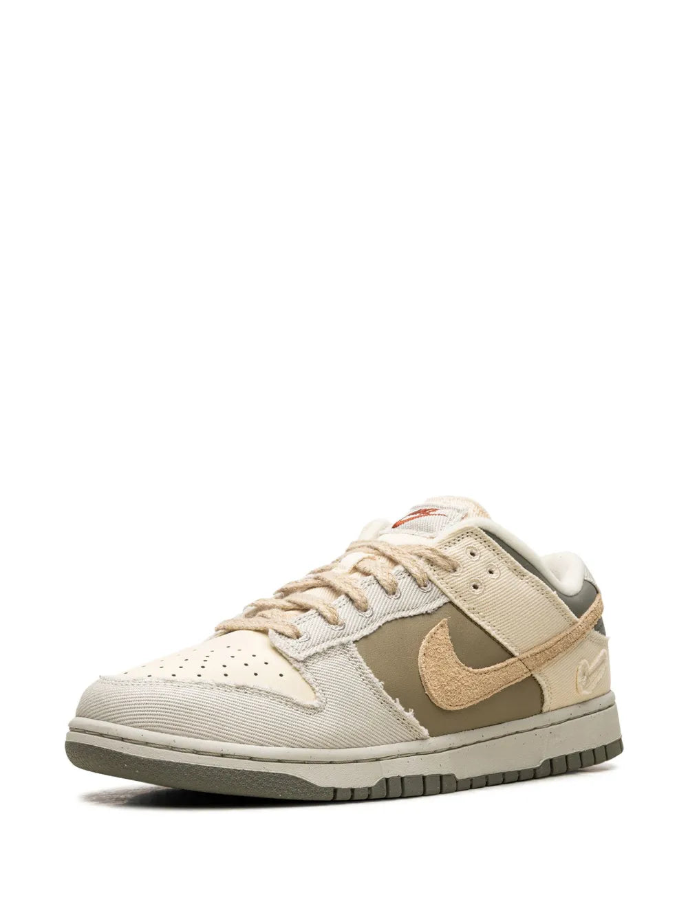 Nike Dunk Low sneakers with beige overlays and tan Swoosh on the side