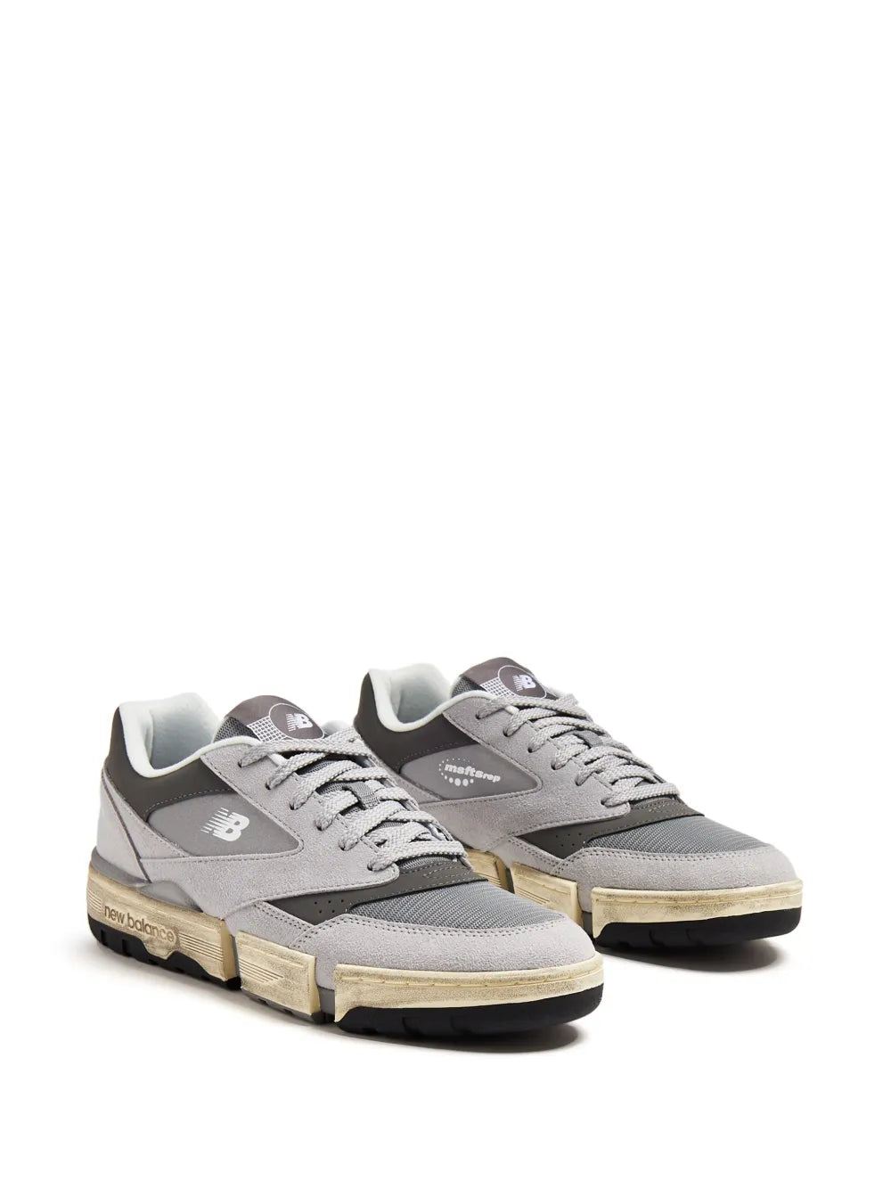 New Balance suede low-top sneakers, ash grey and black, two-piece lace-up design.