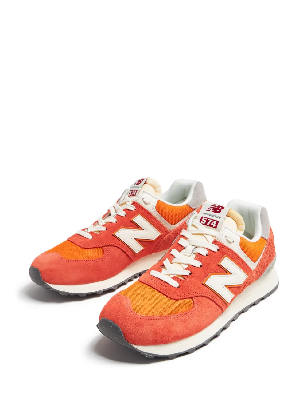 New Balance 574 suede color-block sneakers, orange/red pair with cream laces and N logo