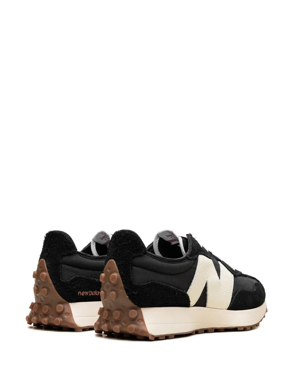 Low-top sneakers heel view in black with cream/white branding panel and gum sole