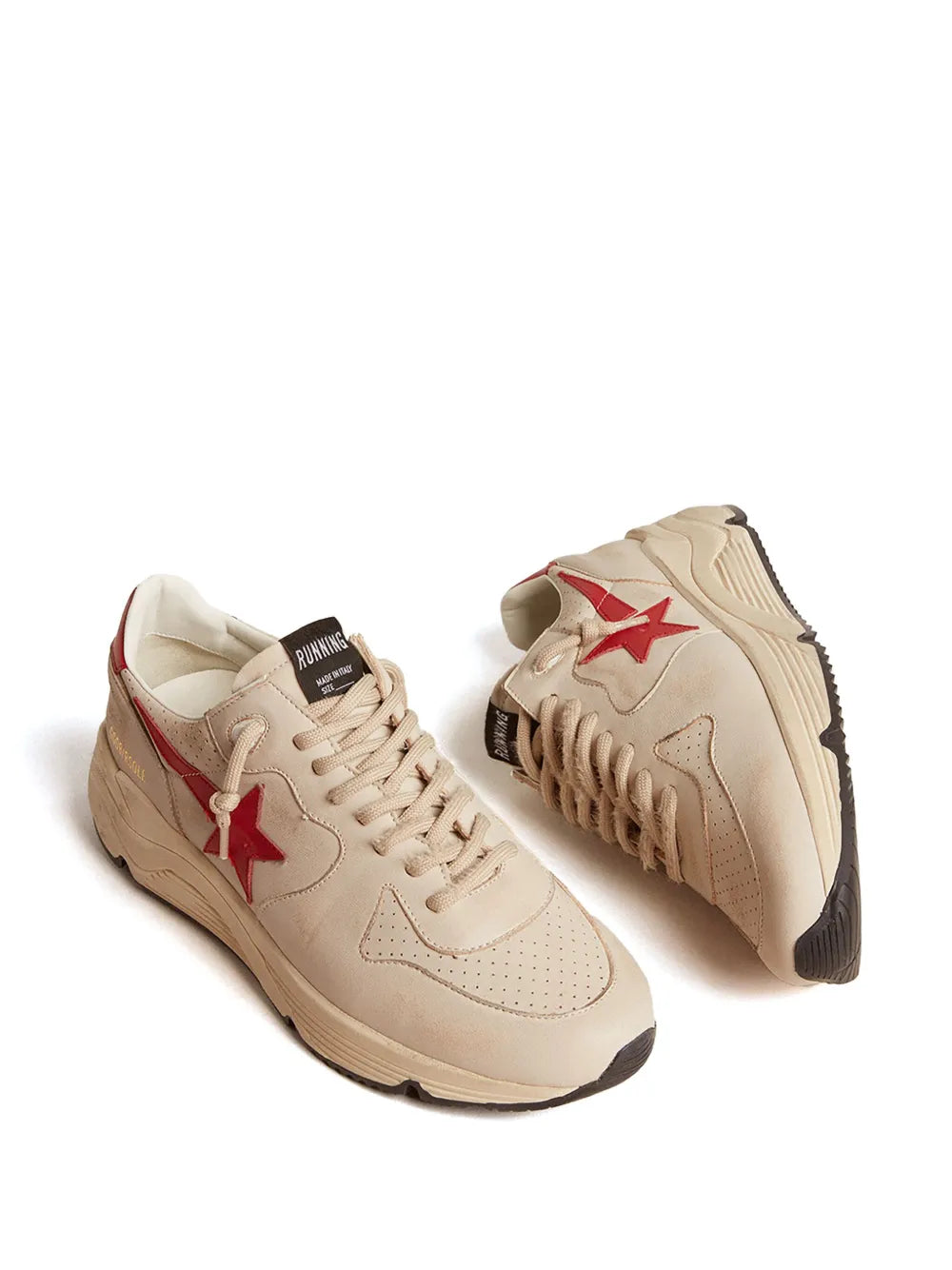 Beige low-top sneakers, side view, red star detail and textured rubber sole.