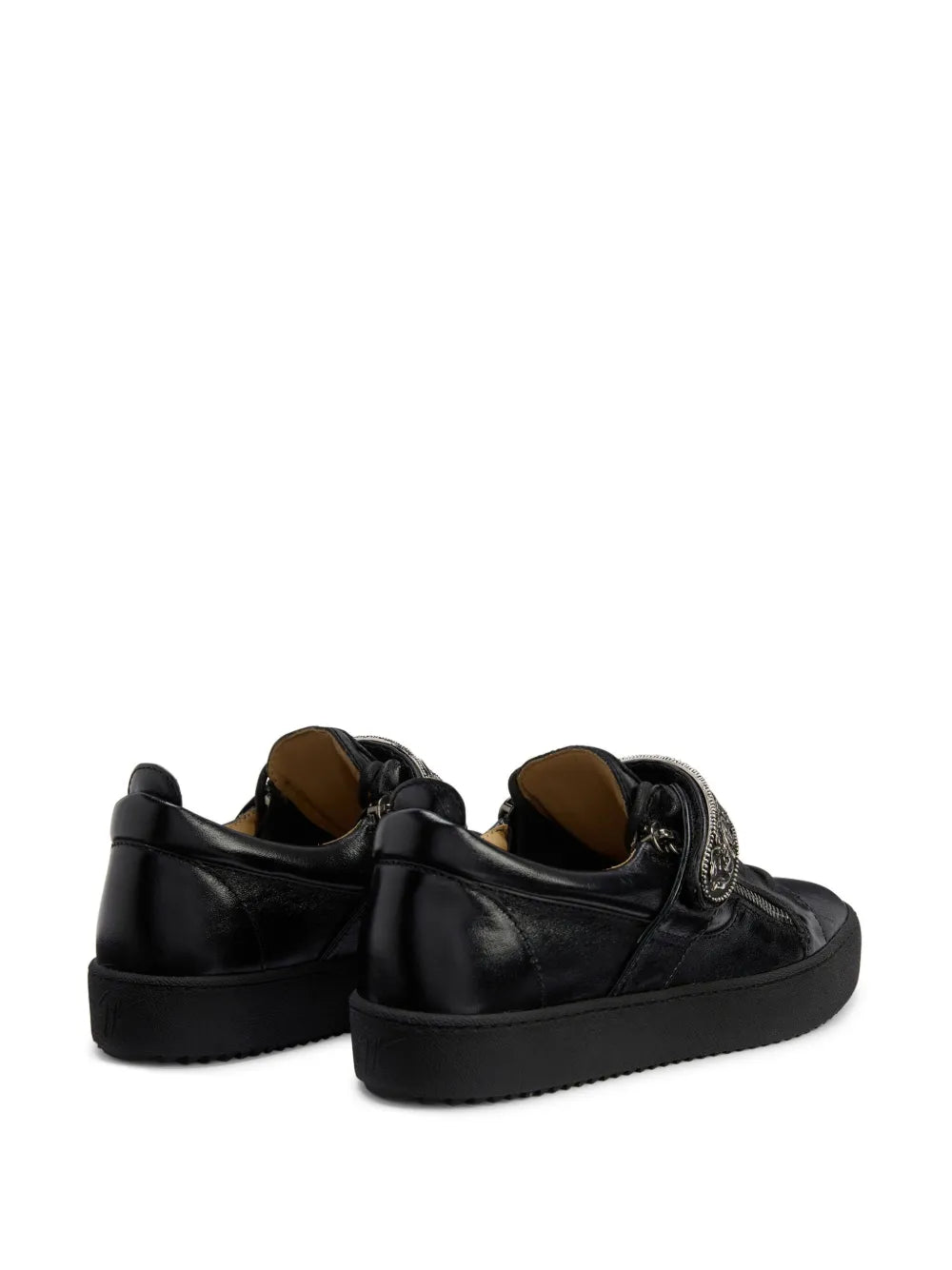 Black low-top sneakers, rear view with padded collar and lace-up closure
