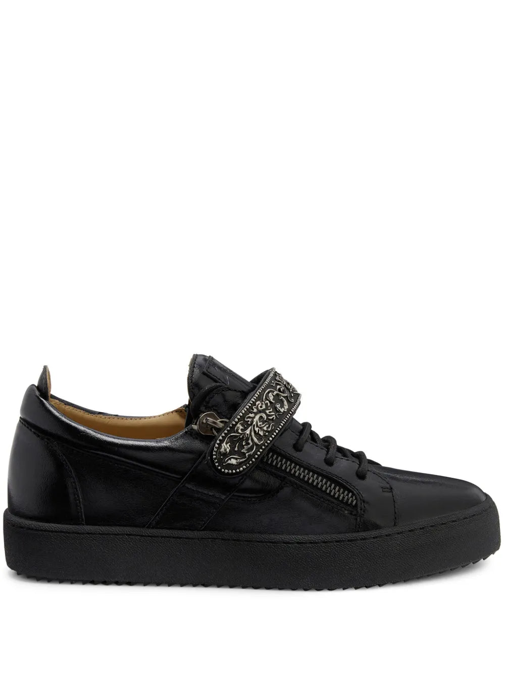 Black low-top sneakers with lace-up front and ornate side zip detail