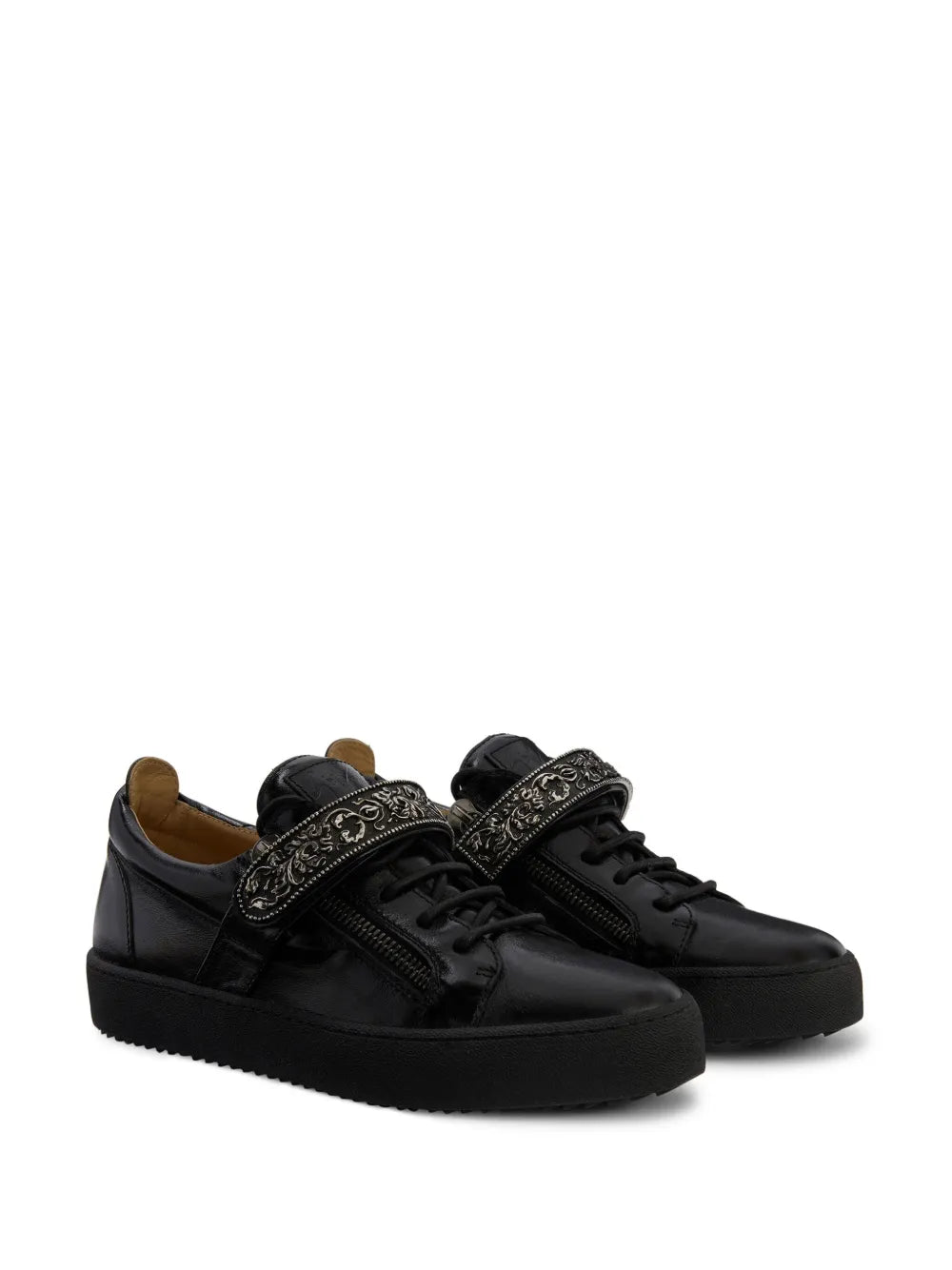 Pair of black low-top lace-up sneakers with ornate side-zip ornament