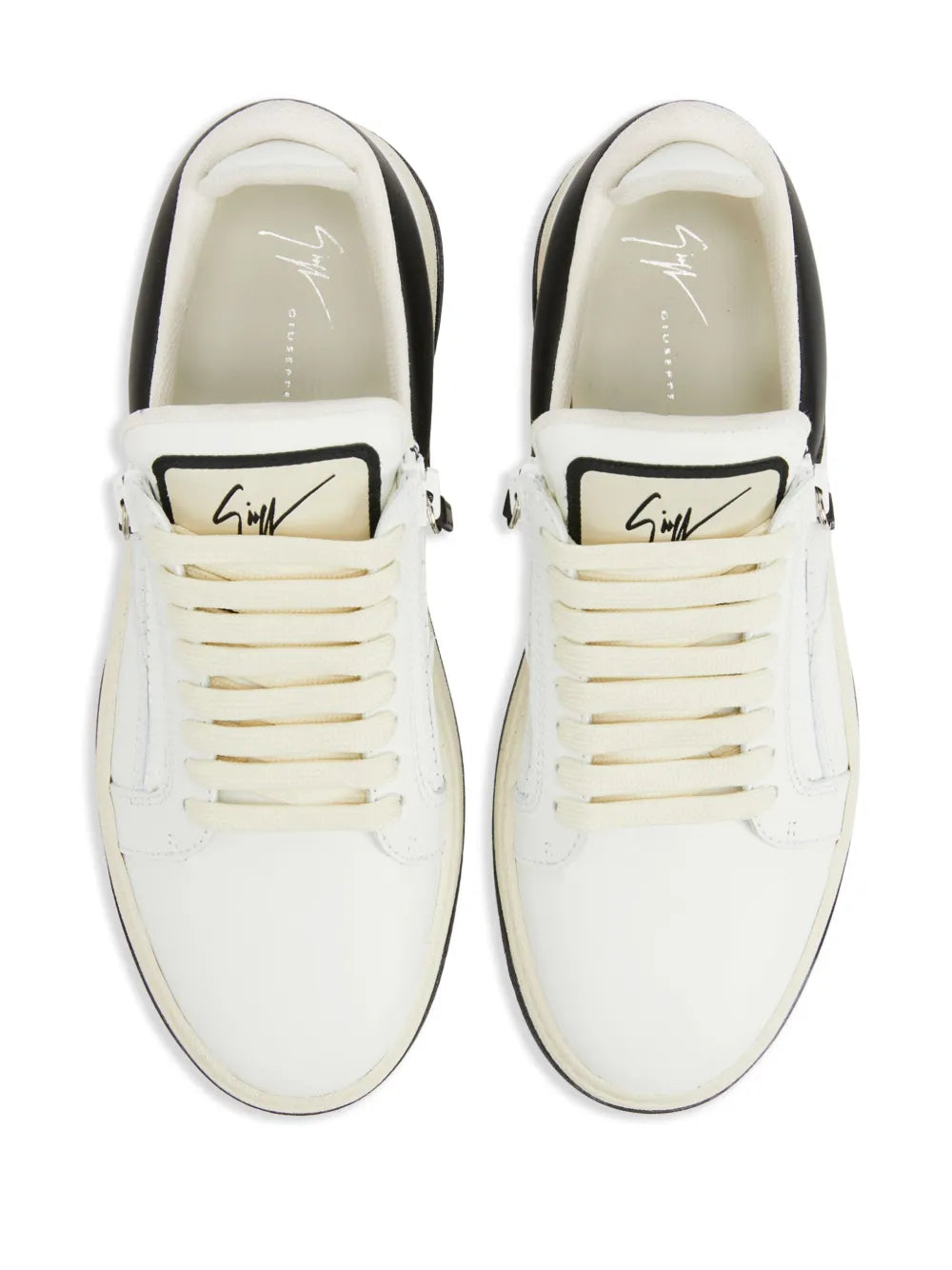 Off-white low-top sneakers with lace-up front and black heel trim