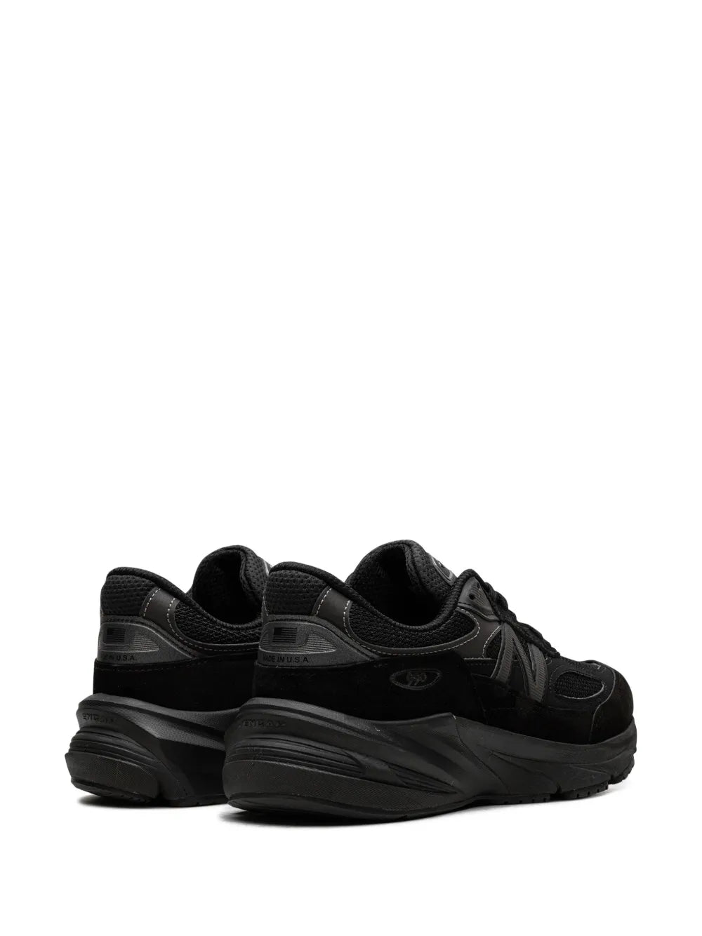 Black New Balance 990V6 sneakers with padded heel and lace-up closure, rear view.