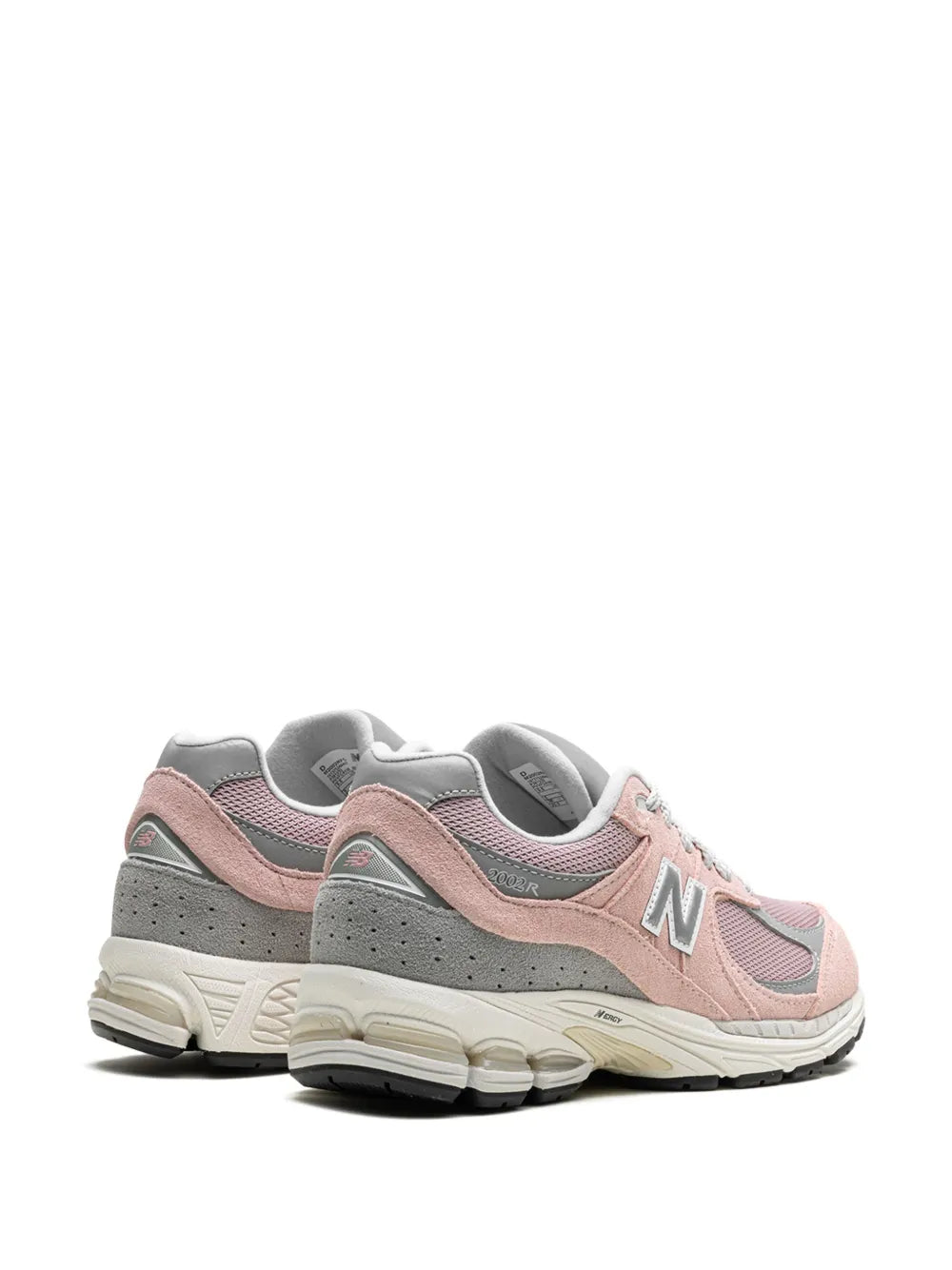 Light pink New Balance 2002R sneakers, angled back view with grey heel and N logo