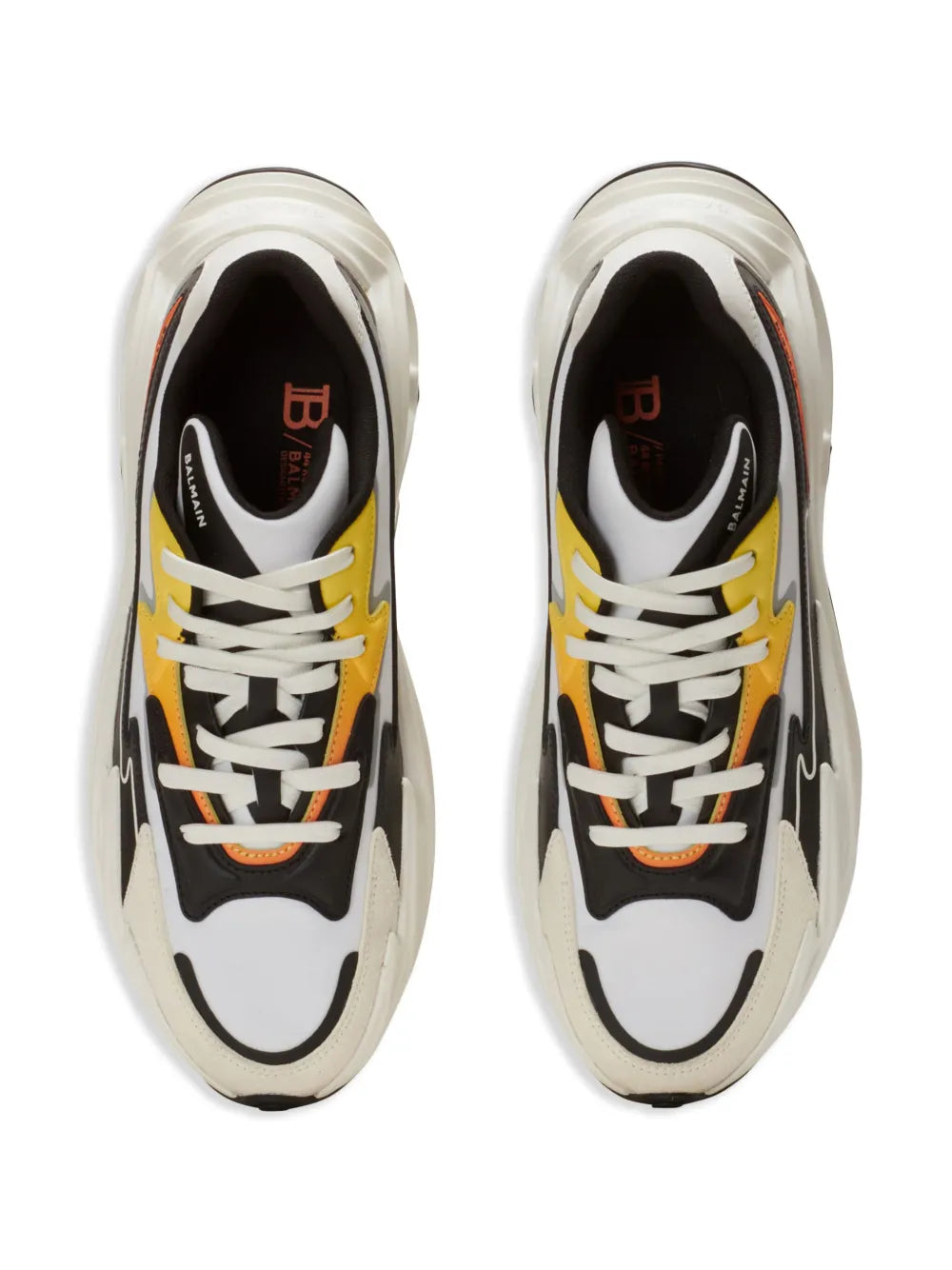 Pair of white and black lace-up trainers with orange details and round toe