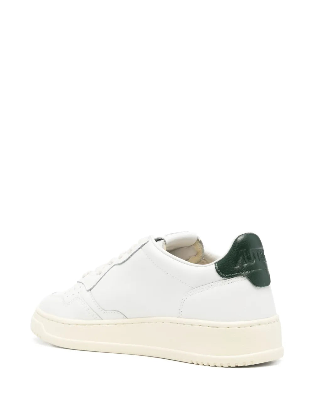 White leather low-top sneaker with green heel tab and cream rubber sole