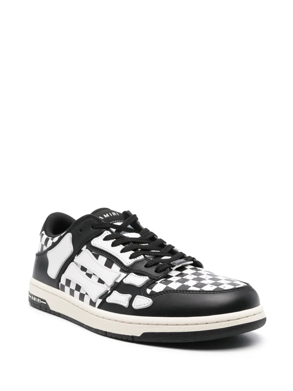 Black low-top sneakers with white checkered toe, lace-up front, and padded tongue