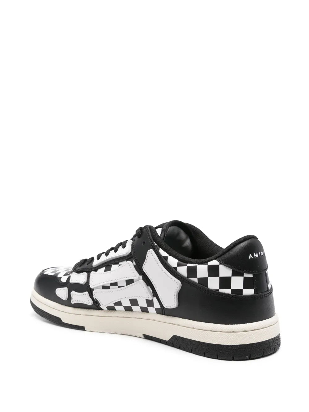 Black and white low-top sneakers with checkered side stripes and chunky rubber sole