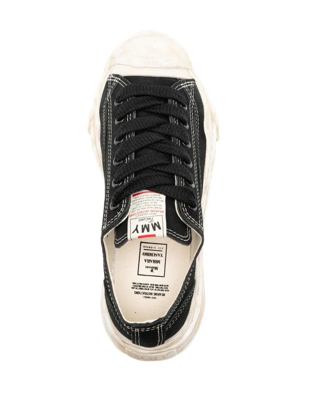 Black lace-up sneakers with interior label, cream lining, and off-white sole
