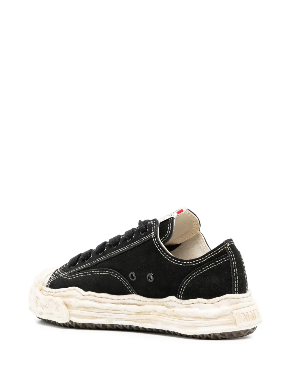 Black low-top sneakers with textured off-white midsole and heel tab detail