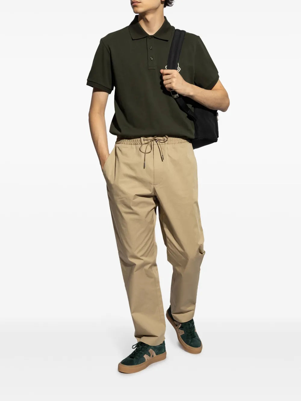 Moncler Monaco M sneakers worn with khaki drawstring trousers; emerald suede, gum sole
