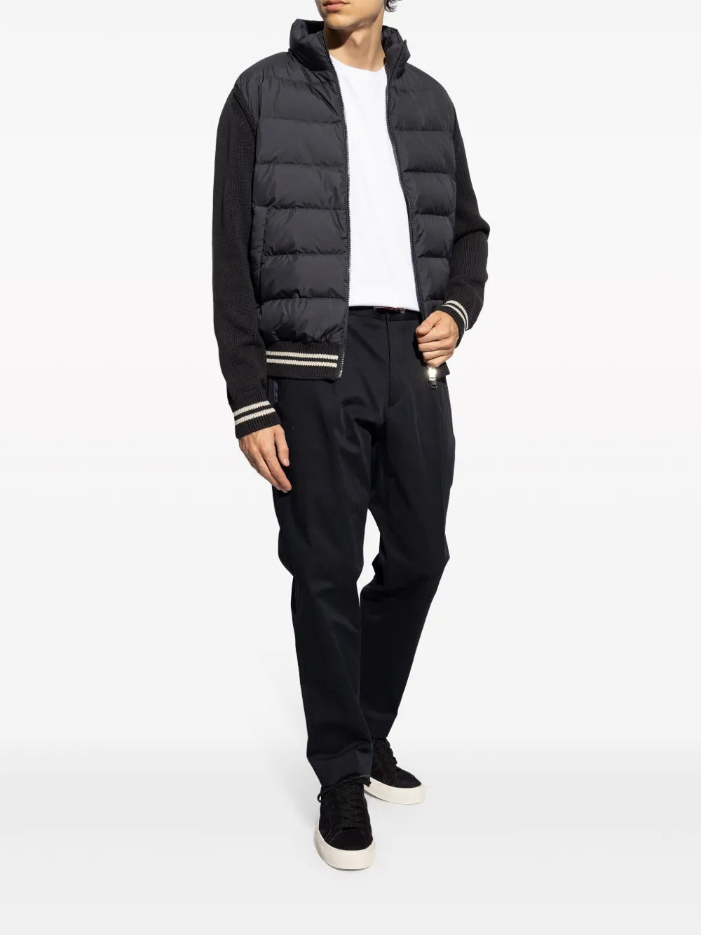 Black low-top sneakers with white sole worn with dark pants