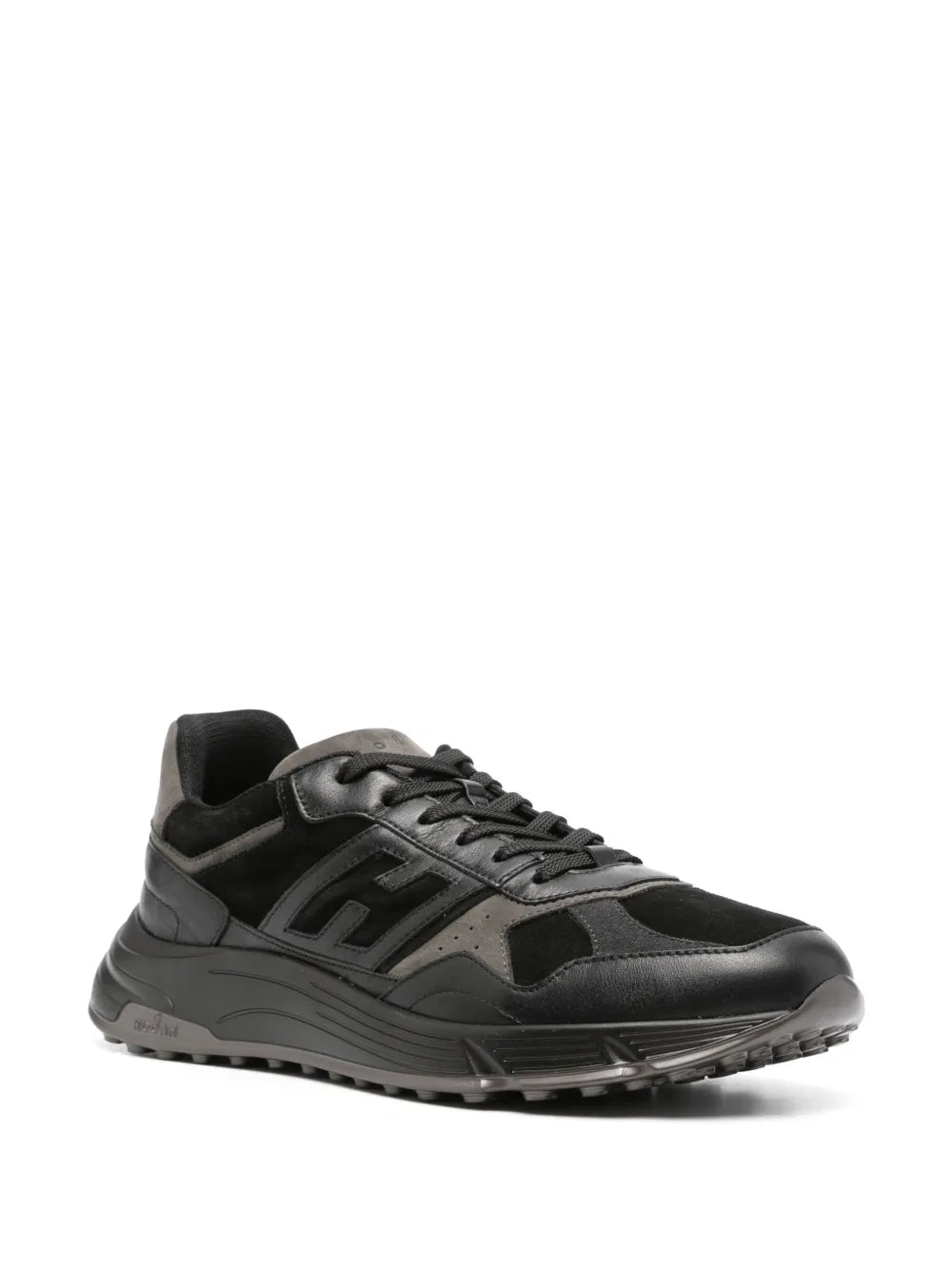 Black low-top lace-up sneakers, side view with geometric logo details and chunky sole