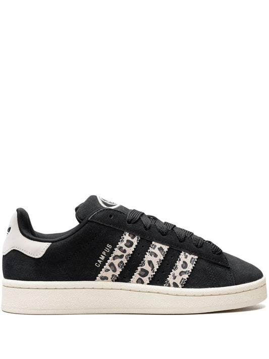 Black low-top sneakers with patterned three stripes, white heel panel, off-white sole