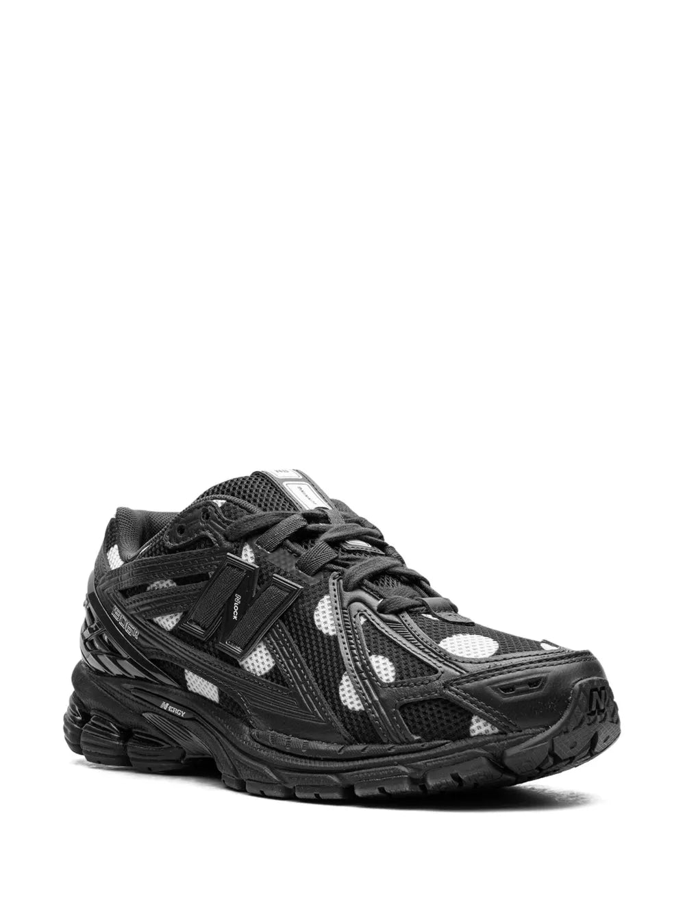 New Balance 1906R sneaker, side view: black mesh with white polka-dot details, lace-up
