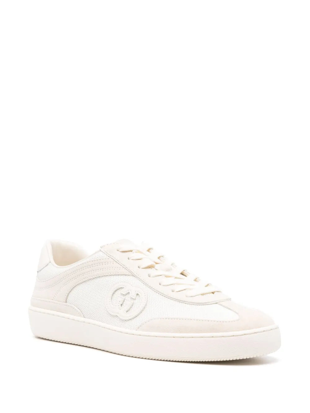 White Gucci low-top sneakers with interlocking G emblem and lace-up design
