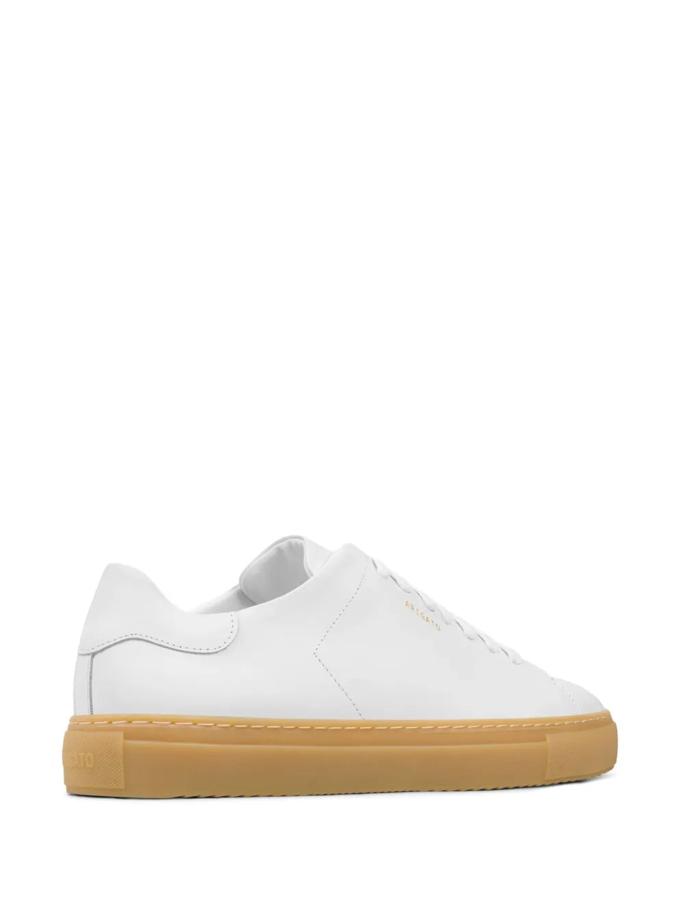 White low-top sneakers with contrast stitching, gum-brown outsole, lace-up