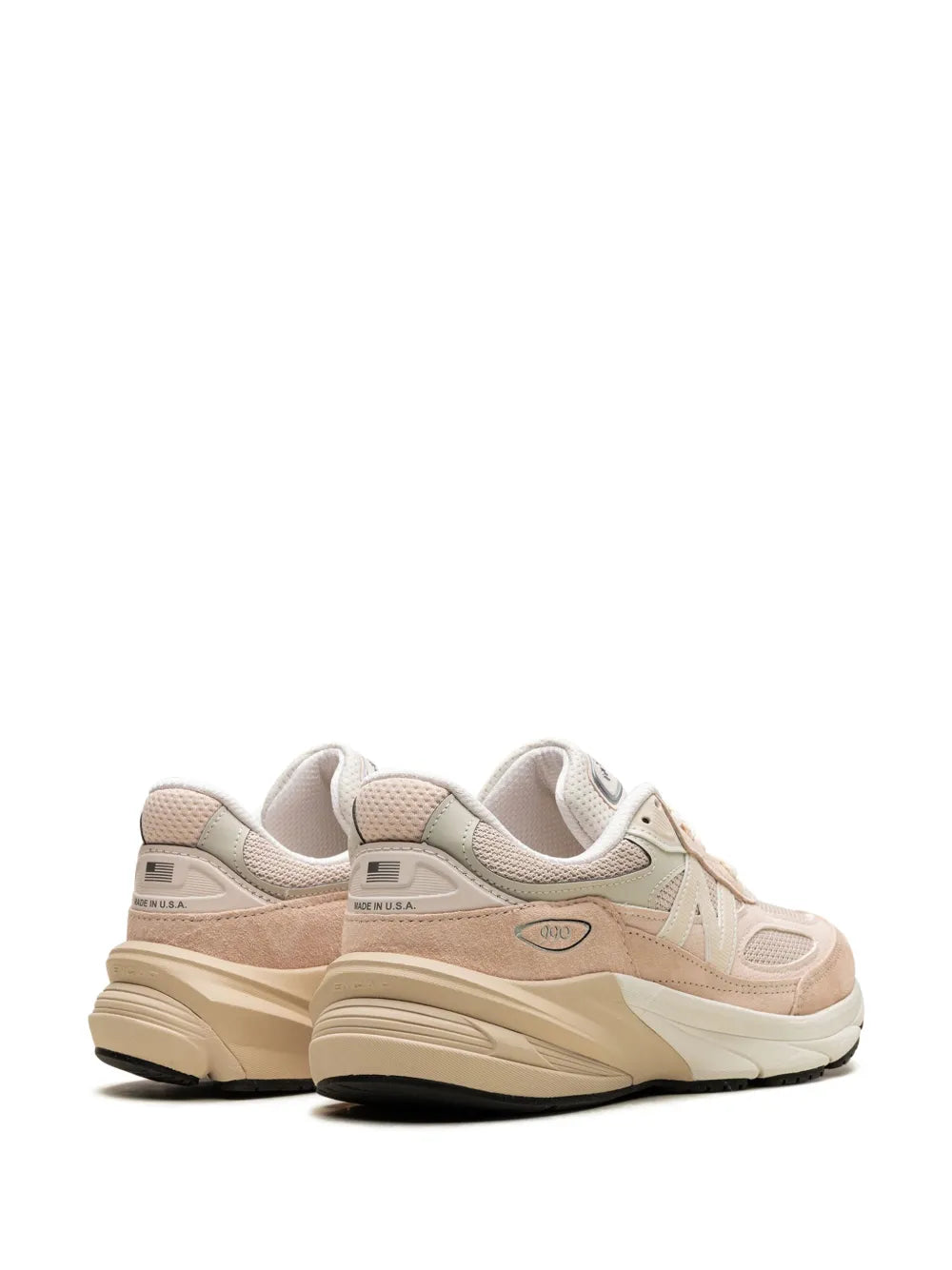 Light pink sneakers rear quarter view with padded heel collar and layered cream sole