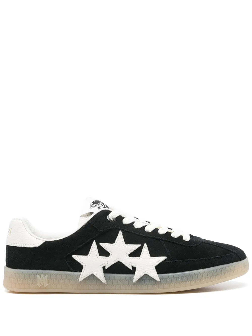 Black low-top sneakers with white laces and two star appliques on the side
