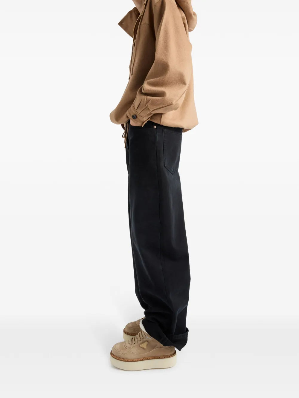 Suede mid-top sneakers on person’s feet with shearling collar and lace-up design