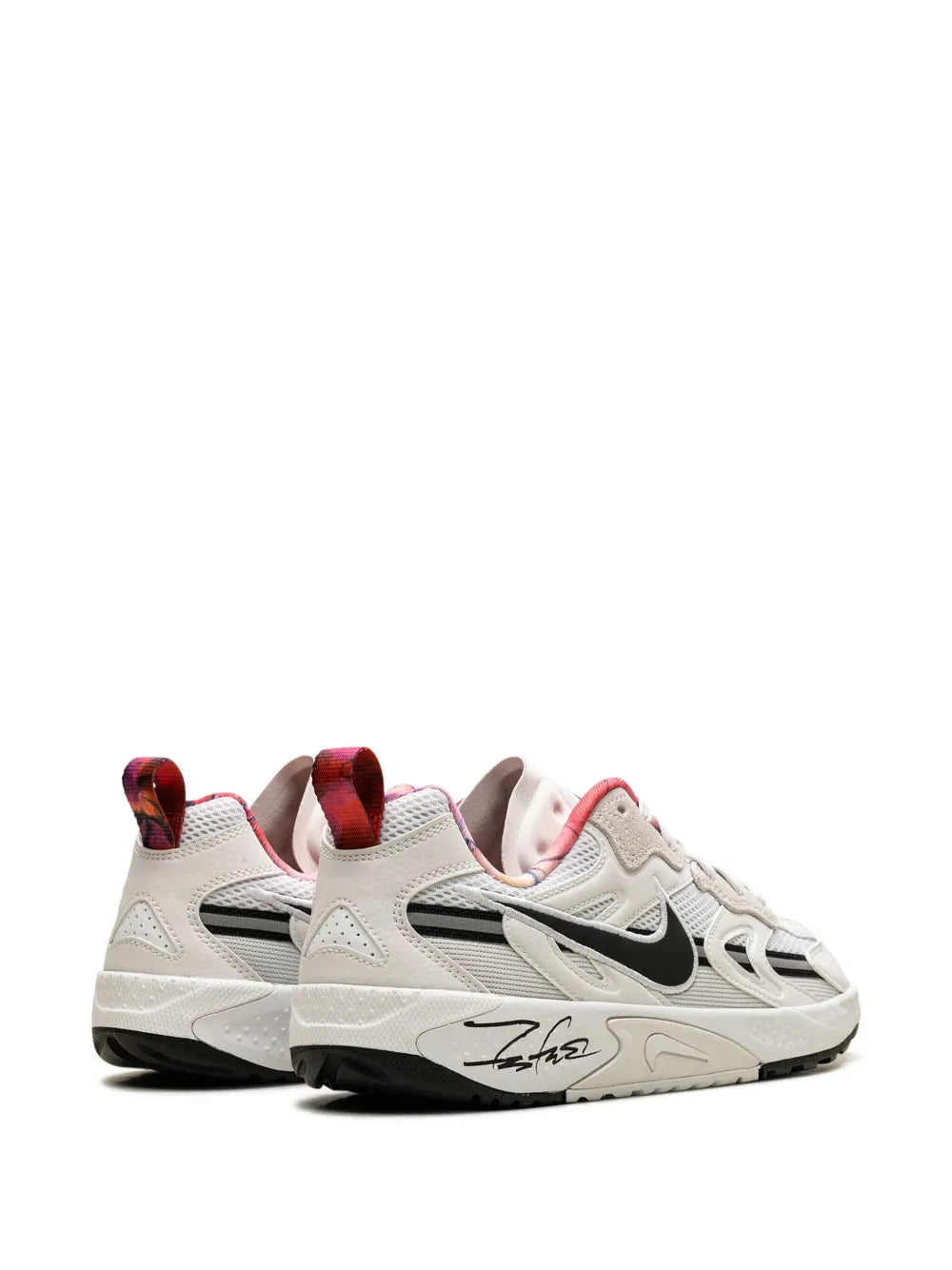 Nike white training sneaker side view with multicolor lining and black swoosh
